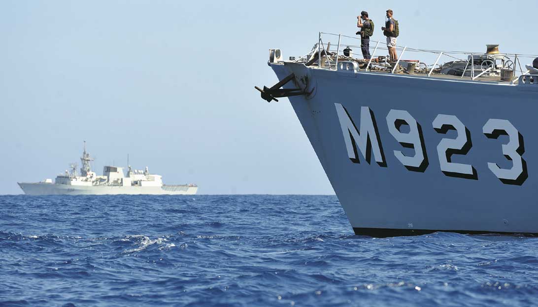 Pictured: Charlottetown provides protection for Belgian mine-hunter Narcis during clearance operations off the Libyan coast. Photos: Cpl Chris Ringius/Canadian DND.